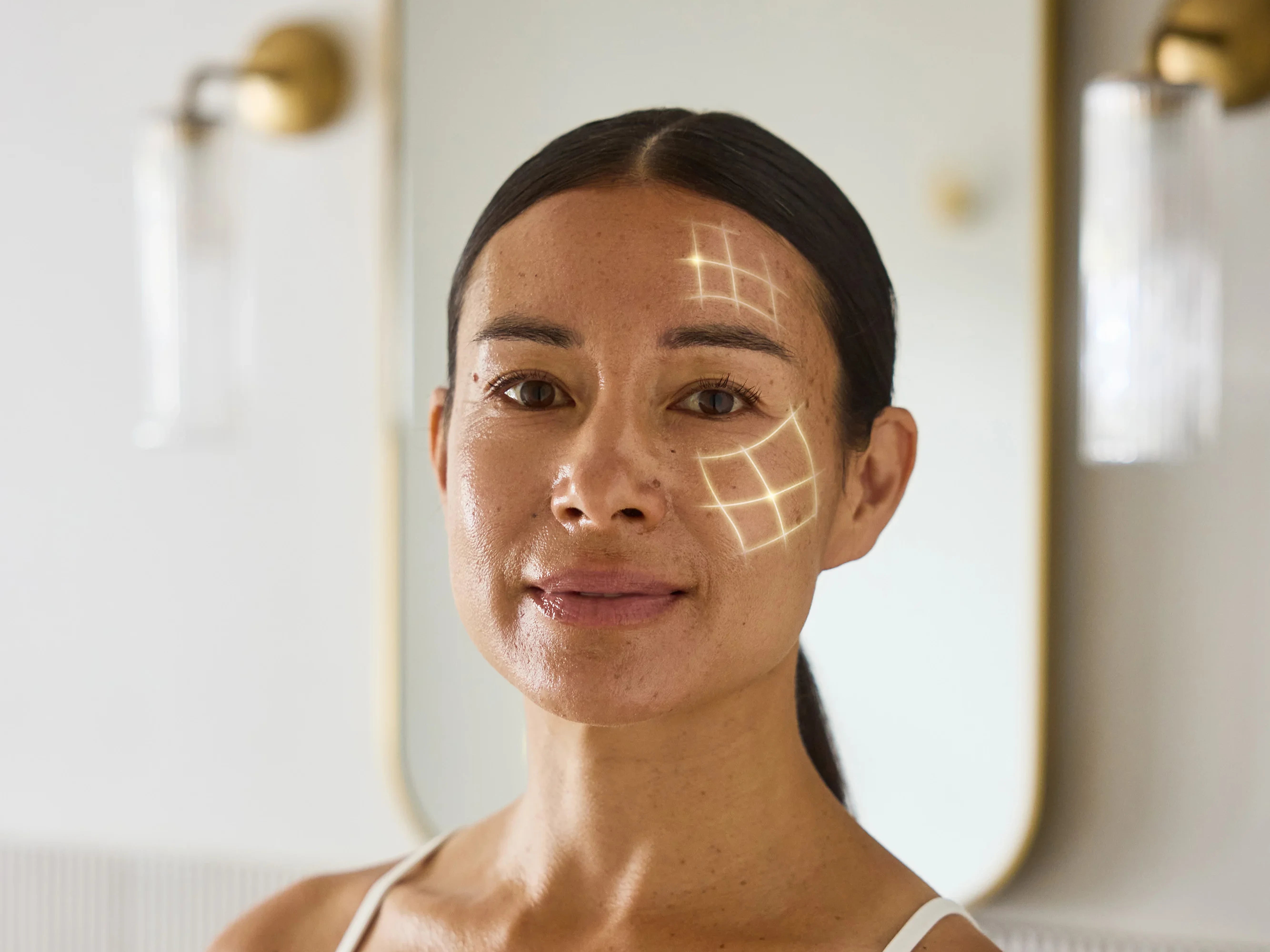 Woman with digital light patterns on her face in a bathroom setting