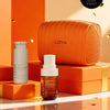 LOYA skincare products on orange boxes with a LOYA bag, against an orange background.