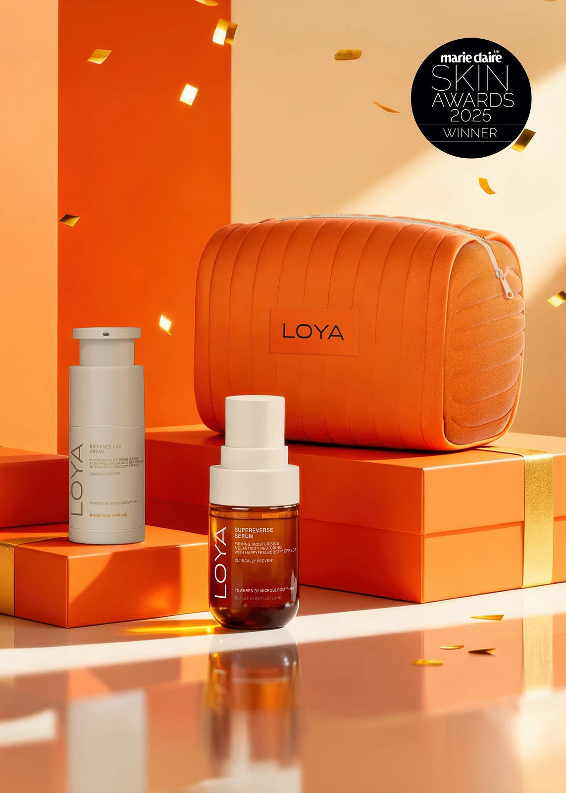 LOYA skincare products on orange boxes with a LOYA bag, against an orange background.