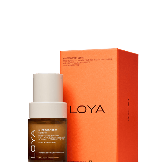 Loya Supercorrect Serum bottle with a white cap next to its bright orange packaging box, set against a solid dark green background.